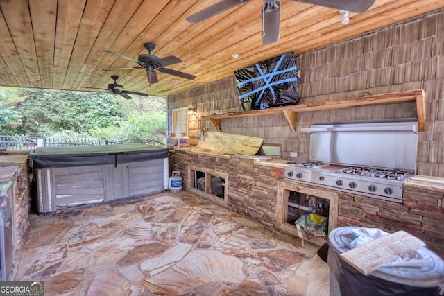 view of patio with ceiling fan, area for grilling, and a hot tub