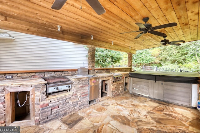 view of patio / terrace featuring ceiling fan, area for grilling, and exterior kitchen