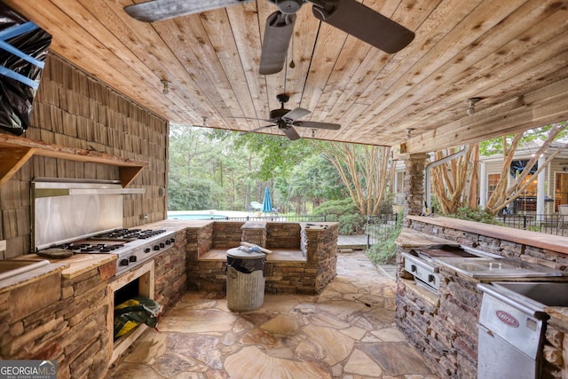 view of patio with ceiling fan and an outdoor kitchen