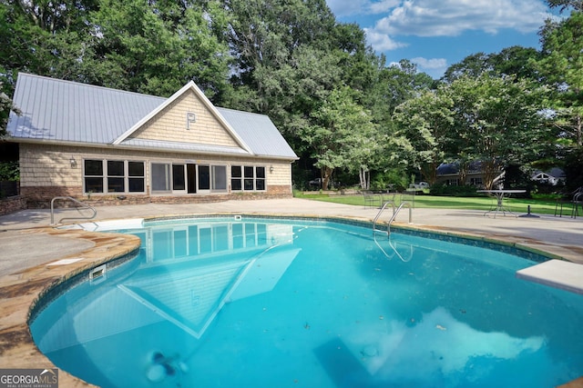 view of swimming pool with a patio