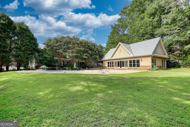 back of property featuring a yard