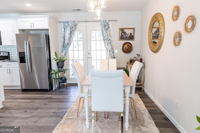 dining room with french doors and dark wood-type flooring