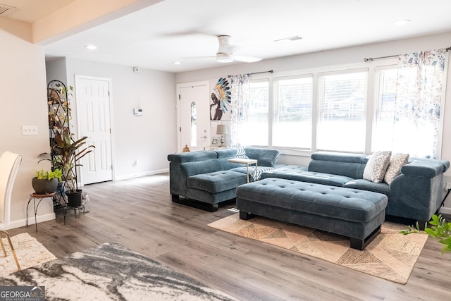 living room with hardwood / wood-style flooring and ceiling fan