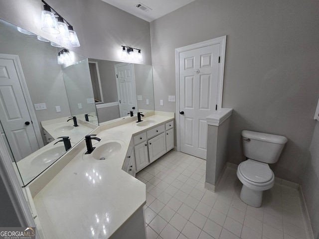 bathroom featuring tile patterned floors, vanity, and toilet