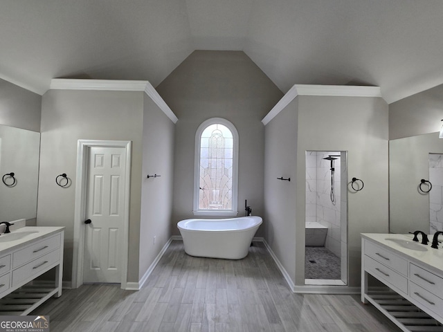 bathroom featuring vanity, hardwood / wood-style flooring, vaulted ceiling, and independent shower and bath