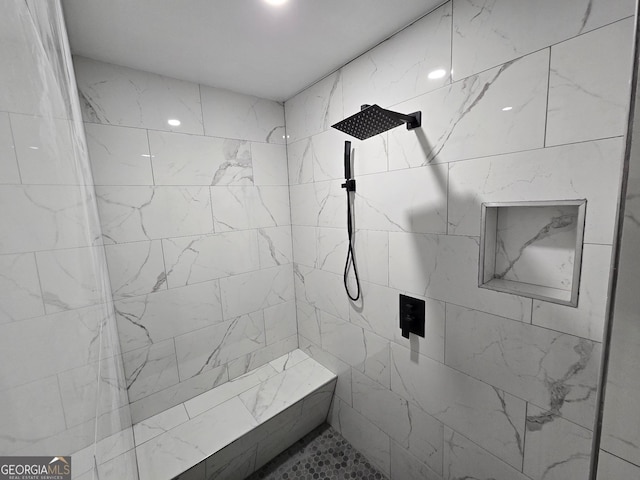 bathroom with a tile shower