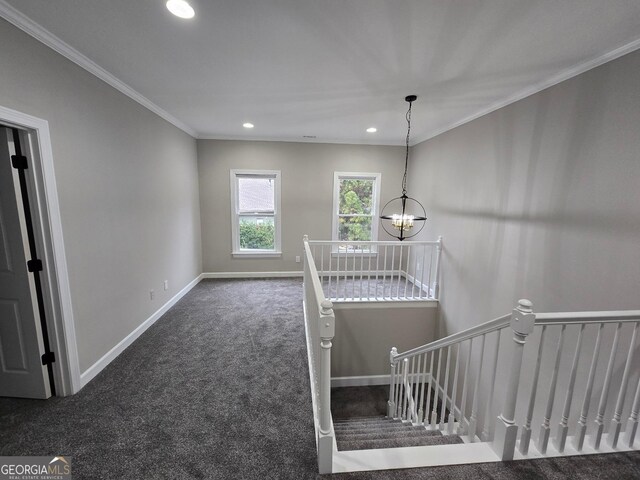 staircase with a chandelier, carpet floors, and ornamental molding