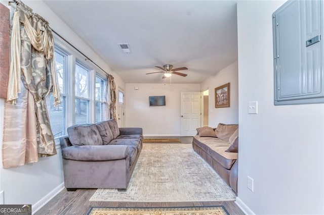 living room featuring electric panel, ceiling fan, and hardwood / wood-style flooring