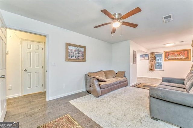 living room featuring ceiling fan and wood-type flooring