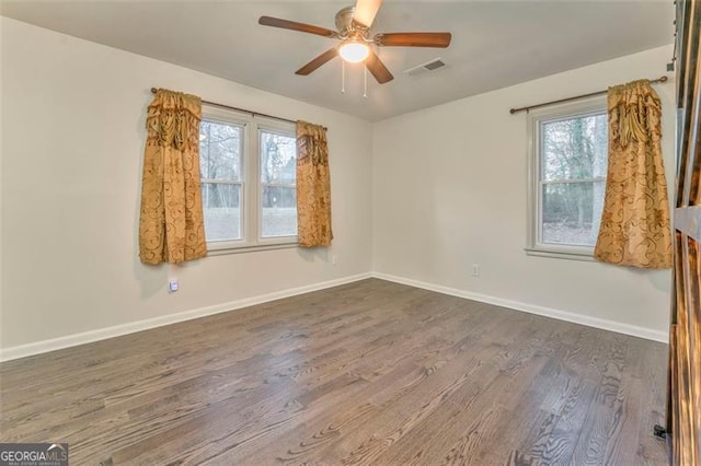 unfurnished room featuring dark hardwood / wood-style flooring and ceiling fan