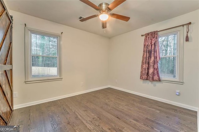 spare room with dark hardwood / wood-style floors and ceiling fan