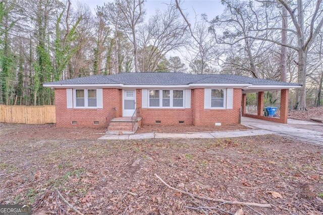 single story home featuring a carport