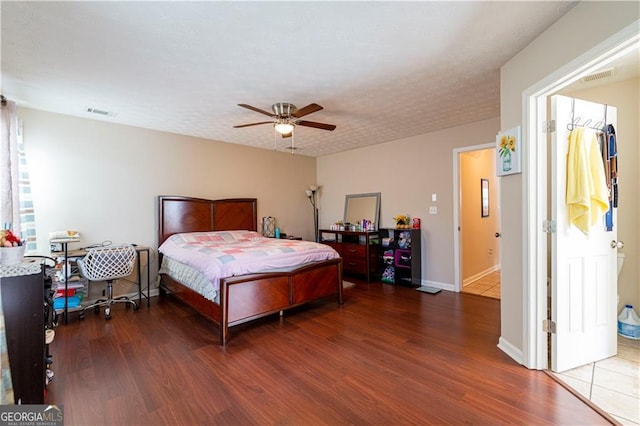 bedroom with ceiling fan and dark wood-type flooring