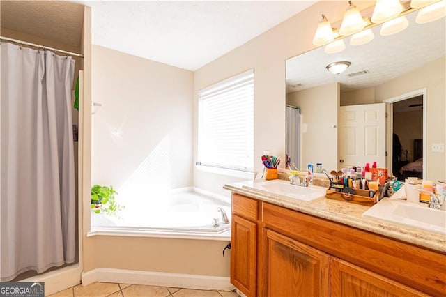 bathroom featuring tile patterned flooring, vanity, and a bath