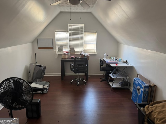 home office with ceiling fan, dark hardwood / wood-style flooring, and vaulted ceiling