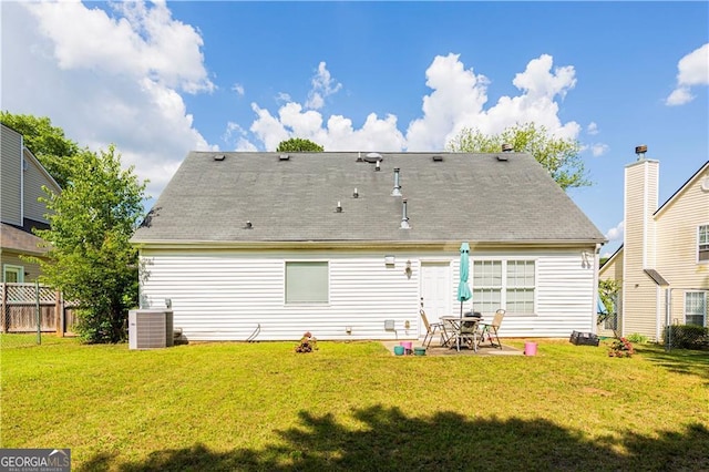 rear view of property with a yard and cooling unit