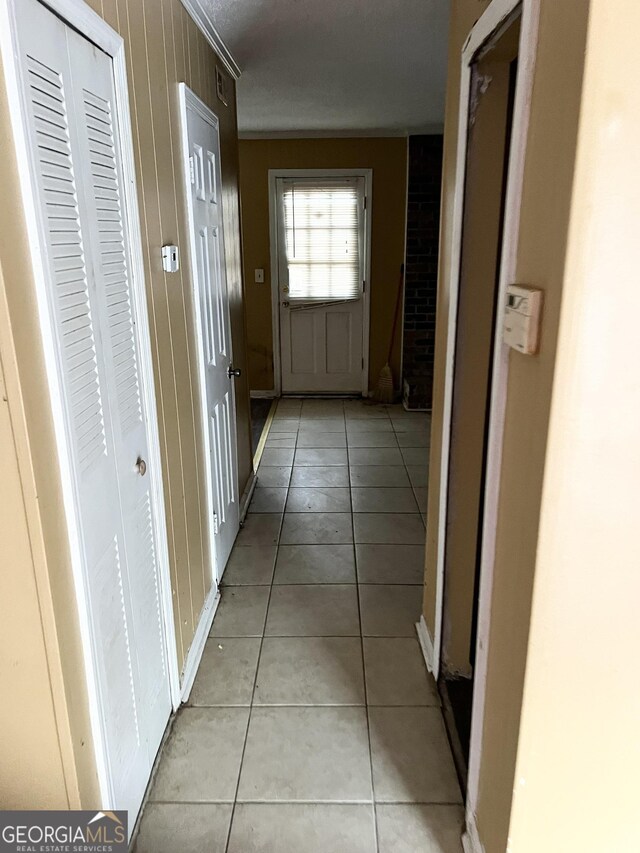 6354 Shannon Pkwy Unit 30D, Union City, GA 30291 - hall featuring light tile patterned floors and wooden walls