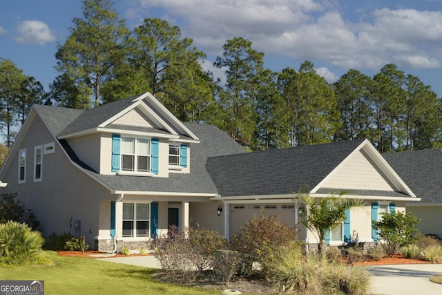 view of front of property with a garage and a front lawn