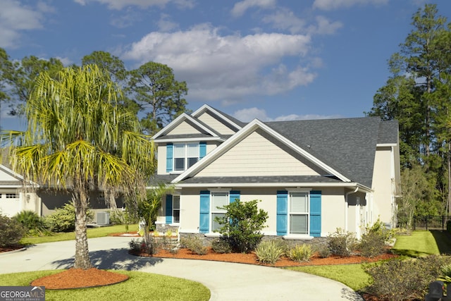 craftsman house with central AC unit and a front lawn