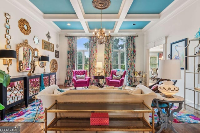 sitting room with coffered ceiling, an inviting chandelier, beamed ceiling, hardwood / wood-style floors, and ornamental molding