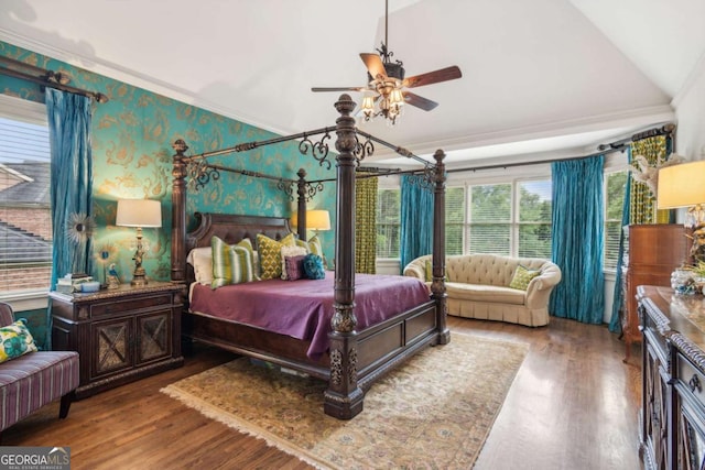 bedroom featuring wood-type flooring, ornamental molding, ceiling fan, and lofted ceiling