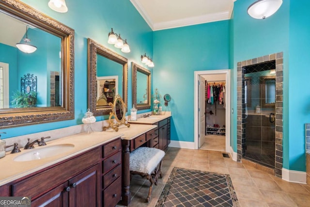 bathroom featuring vanity, tile patterned floors, a shower with door, and ornamental molding