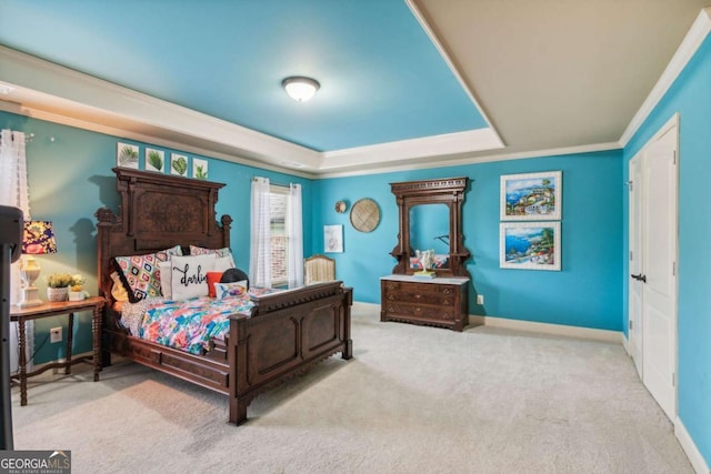 carpeted bedroom with crown molding and a tray ceiling