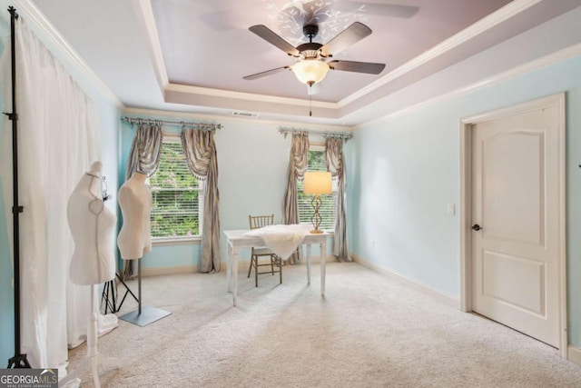 interior space featuring a raised ceiling, light carpet, and crown molding