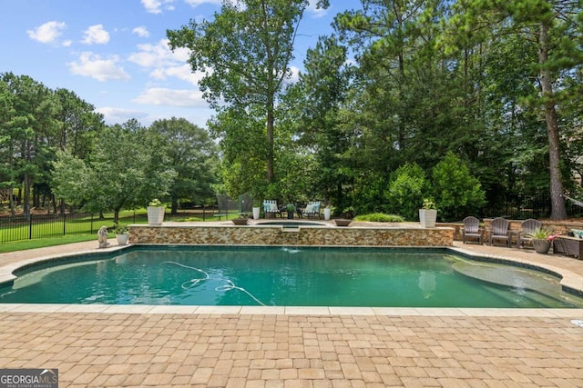 view of swimming pool with an in ground hot tub and a patio