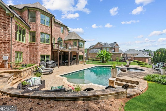 view of swimming pool featuring an in ground hot tub and a patio area