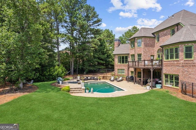 view of swimming pool with a patio area, a yard, and a wooden deck