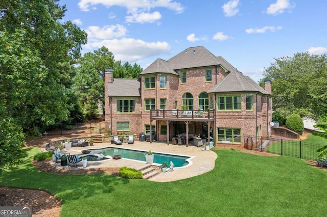 back of house with an outdoor hangout area, a swimming pool with hot tub, a patio area, and a yard