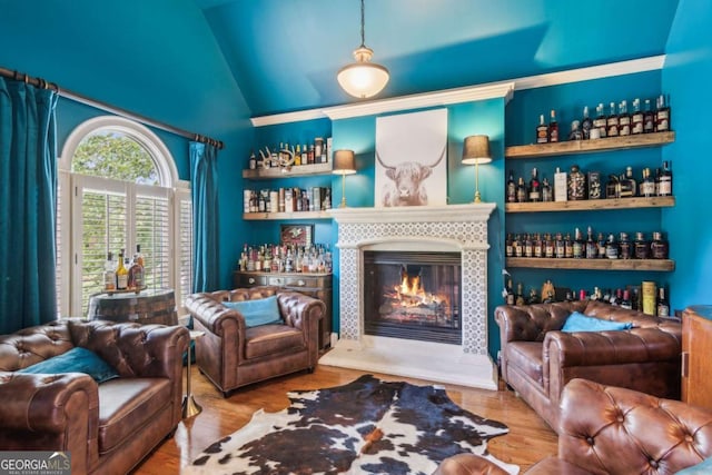 sitting room with wood-type flooring and vaulted ceiling