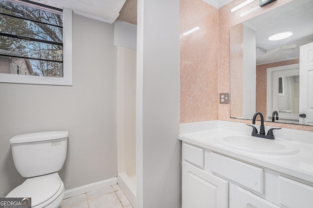 bathroom featuring ornamental molding, a textured ceiling, vanity, tile patterned flooring, and toilet