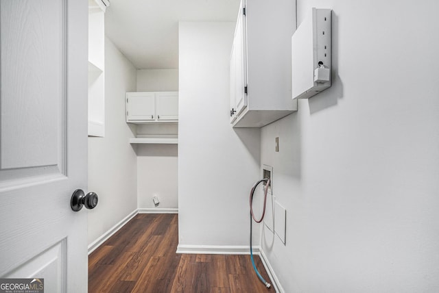 laundry room featuring cabinets, hookup for a washing machine, and dark hardwood / wood-style floors