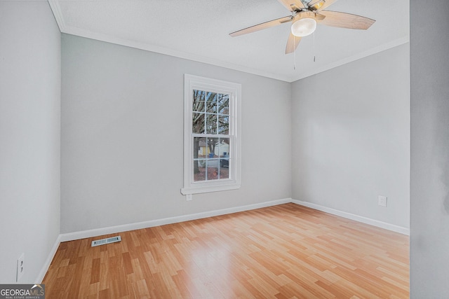 unfurnished room with hardwood / wood-style floors, ceiling fan, and ornamental molding