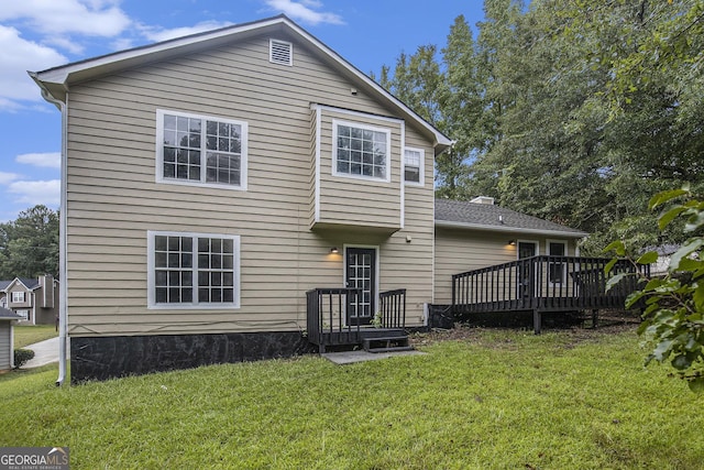 back of house with a yard and a wooden deck