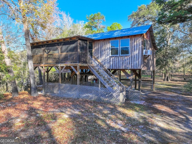 rear view of property with a sunroom