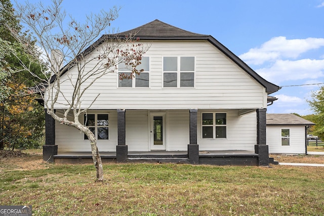 view of front of home with a porch and a front yard