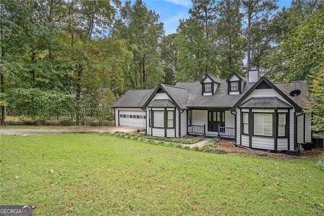 view of front facade featuring a porch, a front yard, and a garage