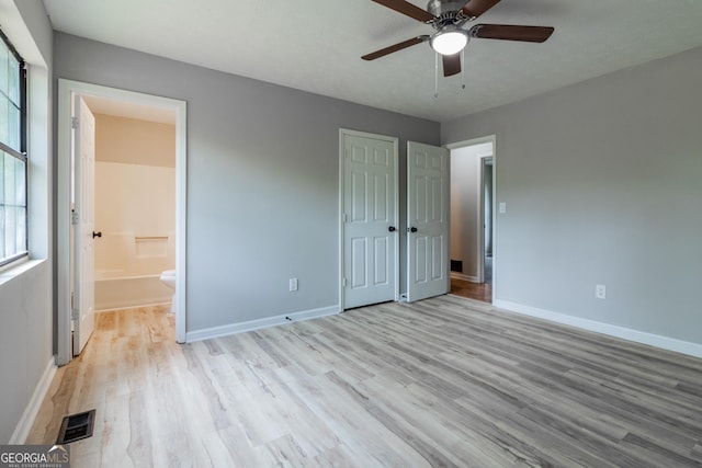 unfurnished bedroom with light hardwood / wood-style floors, ensuite bath, and ceiling fan