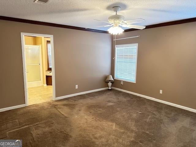 carpeted spare room with crown molding, ceiling fan, and a textured ceiling