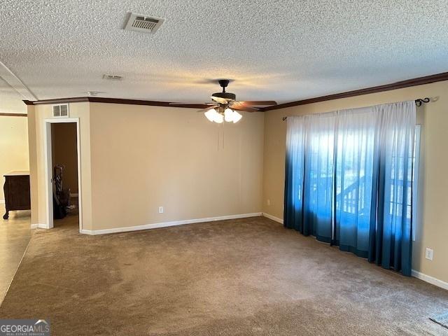 unfurnished room featuring carpet flooring, ceiling fan, ornamental molding, and a textured ceiling