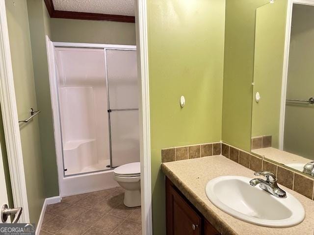 bathroom featuring tile patterned flooring, a textured ceiling, toilet, a shower with door, and vanity