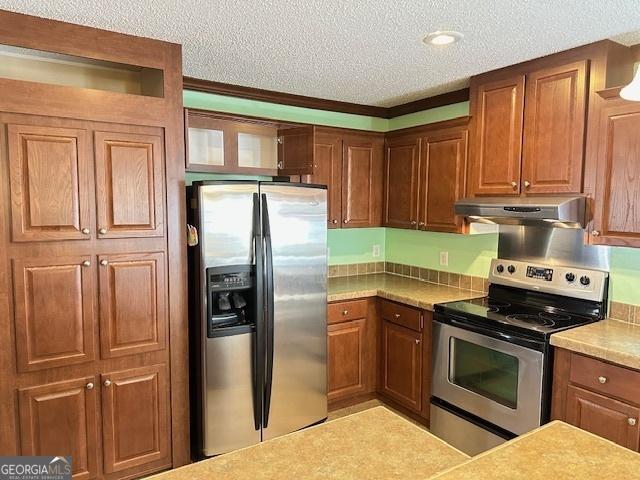 kitchen featuring stainless steel appliances and a textured ceiling