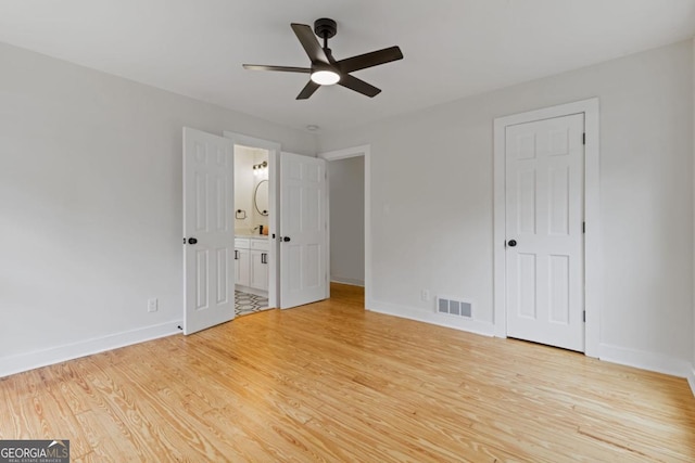 spare room featuring light wood-type flooring, ceiling fan, and ornamental molding