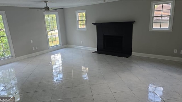 unfurnished living room with ceiling fan