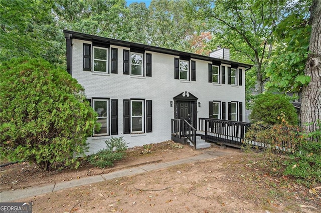 colonial house featuring a wooden deck