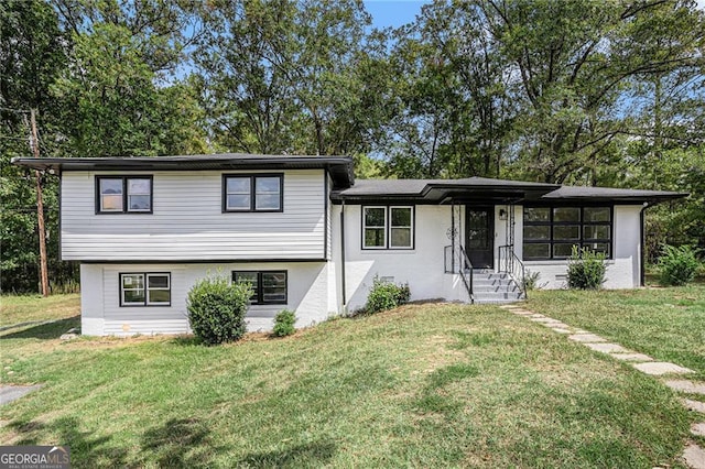 tri-level home with a front lawn