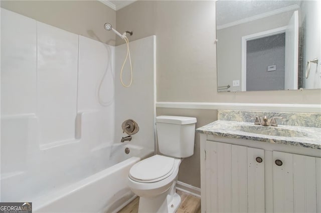 full bathroom with shower / bath combination, ornamental molding, vanity, hardwood / wood-style floors, and toilet